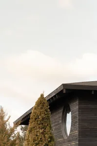 Modern building with circular window made of wood