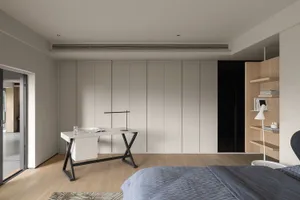 A minimalistic bedroom with a large bed, a sleek white desk, and a wooden bookshelf.