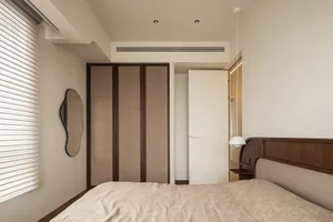 Modern bedroom with wood-textured furniture and light-colored bedding.