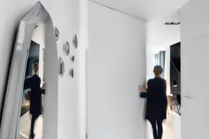 A minimalist apartment with white walls.