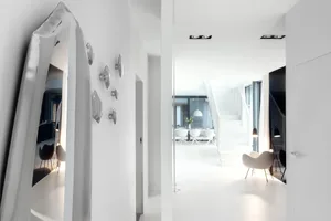 A modern minimalist white interior design with clean lines and a monochromatic color scheme.