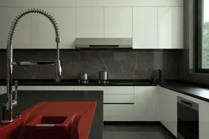Modern kitchen featuring sleek metal appliances and marble countertops.
