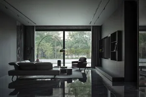 A modern living room with glass windows and a black interior.