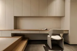 A modern office workspace featuring wooden furniture and a minimalist design.
