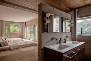 Interior design image of a modern residential bathroom with concrete walls and a double sink vanity.