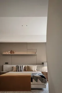 Modern minimalist bedroom with neutral-toned textiles, wood, and matte-finish metal.