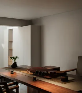 Modern home office featuring a wooden table with minimalist design elements and a serene workspace.