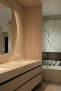 Modern minimalist bathroom with marble walls and sink.