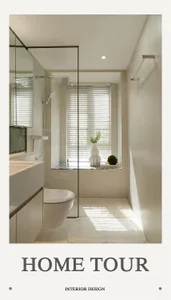 A minimalist bathroom with a white toilet, glass shower enclosure, marble floor, and a window with white blinds and a plant.