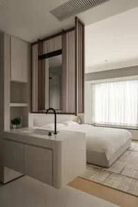 A minimalist bedroom with a wooden panel accent wall and a white bed.