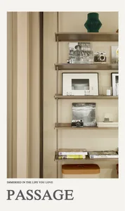 A modern metallic shelf displaying various items such as books, photographs, and decorative objects.