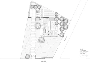 Floor plan of a modern residential building with concrete and glass materials.