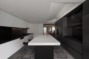 Contemporary kitchen with concrete countertops and minimalist design.