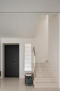 A modern interior with white stairs made of stone material.