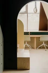 A modern office interior featuring minimalist design principles, with a combination of wood and glass materials, and upholste