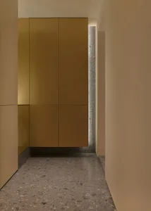 Modern interior design featuring a copper-colored hallway with a terrazzo floor, showcasing contemporary and elegant design e