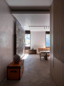 Modern interior design featuring concrete, stone, and wood elements.