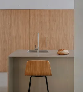 Modern minimalist kitchen with concrete countertops and a bread loaf on the countertop.