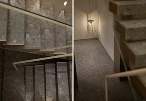 Concrete staircase with glass railings and modern lighting fixture.