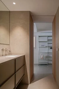 Modern bathroom with concrete walls, minimalist design, and a sleek white sink.