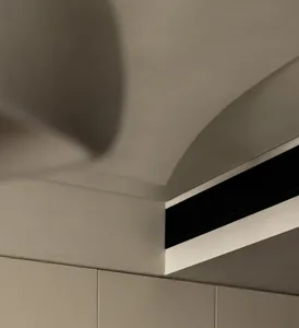 A minimalist interior design featuring a concrete accent wall.