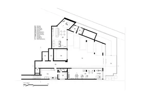 Floor plan of a modern residential building with concrete, glass, and wood materials.