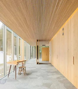 An industrial-style corridor with wooden panels and flooring.