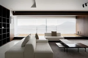 Modern minimalist living room featuring neutral-colored furniture and tiles.