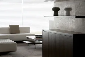 Modern interior design featuring a living room with concrete and metal finishes.