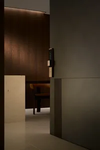 Modern minimalist dining room featuring metal walls and a single wooden chair.