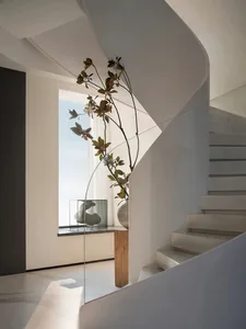 Modern staircase featuring glass railings and minimalist design.