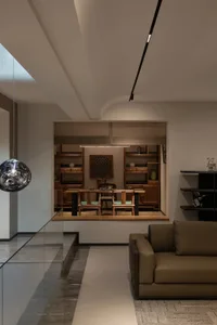 Modern minimalist living room featuring wooden furniture, leather accents, and glass elements.