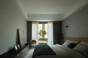 A modern bedroom with textured paper walls and a minimalist design.