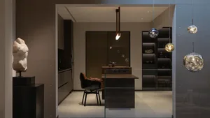 Modern kitchen with metallic finishes, featuring sleek design elements and contemporary fixtures.