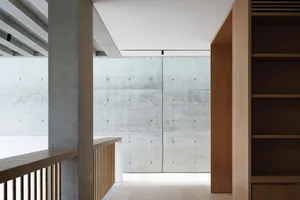 A minimalist modern interior with concrete walls and wooden accents