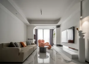 Modern living room with taupe carpet, beige sofa, and white and orange striped armchair.
