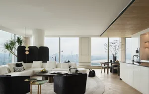 Modern living room with white corner sofa, black side chairs, and concrete laminate flooring.