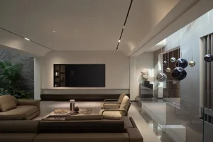 Contemporary living room featuring modern furniture with minimalist design, leather sofas, stone accents, and metal decor.