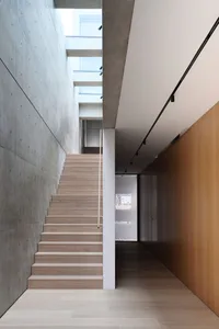 Modern stairwell with concrete flooring, minimalist design.