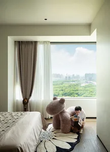 Modern bedroom featuring a comfortable bed and plush textiles in a soft, inviting space.