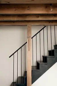 Industrial-style staircase featuring metal railings and wooden steps