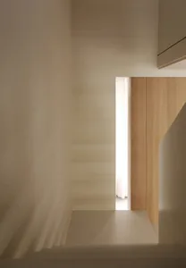 A minimalist interior space with a wooden and white color palette.