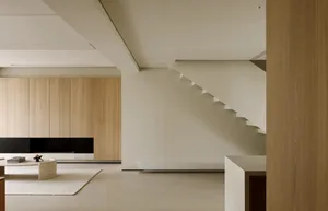 Modern minimalist interior design featuring a floor plan with wood accents and neutral tones.
