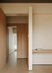 A contemporary kitchen with wooden walls and floors