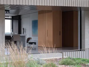 Modern, minimalist residential interior with concrete and wooden elements.