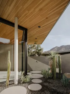 A minimalist outdoor design featuring wooden elements and a modern patio setup.