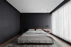 Minimalist bedroom featuring textured wallpaper, modern furniture, and soft lighting.