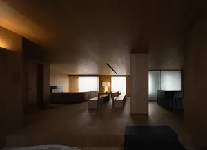 Modern living room with wooden walls, furniture, and floor, featuring a minimalist design style.