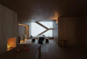 Modern minimalist interior design featuring wooden furniture and flooring.