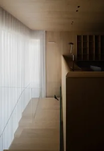 Modern minimalist interior with wooden flooring and walls, minimalistic design elements, and a bird perched on a step.